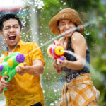 Asian people are using water guns play in the Songkran festival